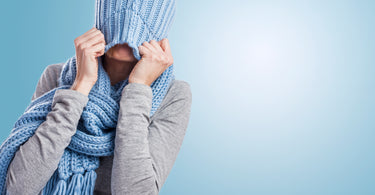 Woman pulling hat down over face